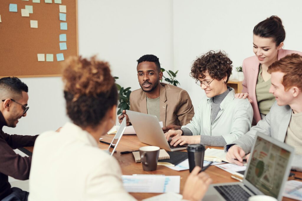 Team of direct sales professionals collaborating at a meeting table.